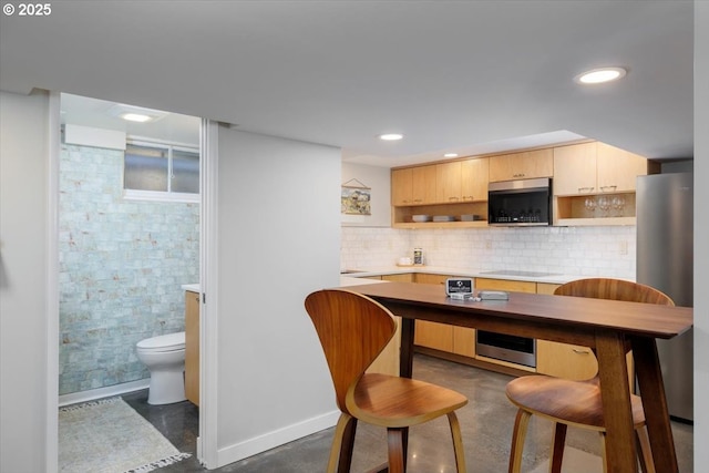 kitchen featuring open shelves, baseboards, light countertops, concrete floors, and appliances with stainless steel finishes