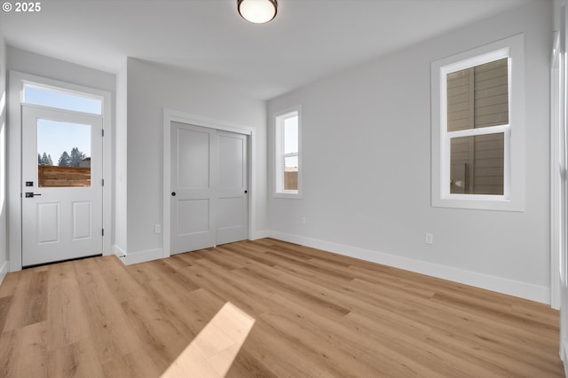 unfurnished bedroom with a closet and light wood-type flooring