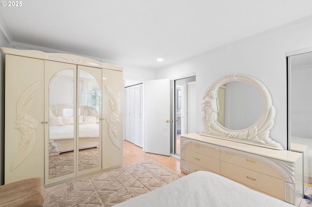 bedroom with recessed lighting, two closets, and crown molding