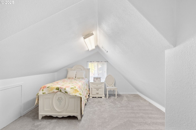 bedroom with lofted ceiling, carpet flooring, a textured ceiling, and baseboards