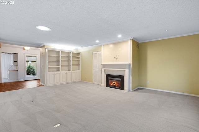 7785 SW Fairway Dr, Wilsonville, OR 97070 - unfurnished living room featuring a textured ceiling, crown molding, light carpet, recessed lighting, and a fireplace