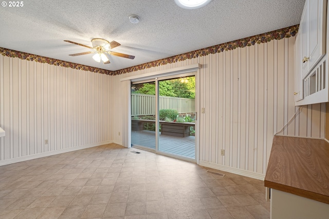 7785 SW Fairway Dr, Wilsonville, OR 97070 - empty room featuring light floors, a ceiling fan, a textured ceiling, a smoke detector, and baseboards