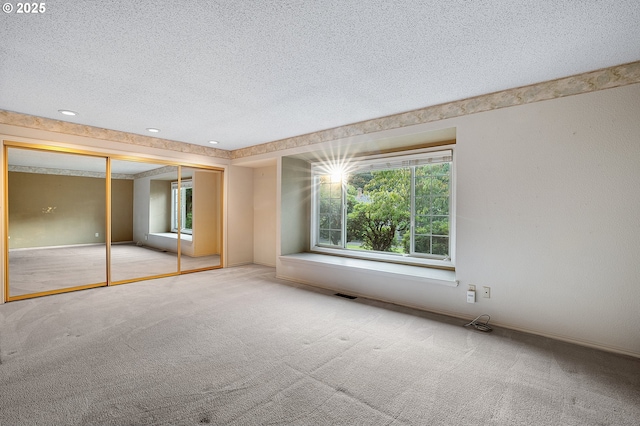 7785 SW Fairway Dr, Wilsonville, OR 97070 - unfurnished bedroom featuring a textured ceiling, carpet floors, and a closet