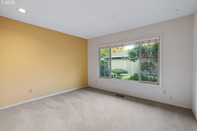 7785 SW Fairway Dr, Wilsonville, OR 97070 - unfurnished room with light colored carpet, baseboards, recessed lighting, and a textured ceiling