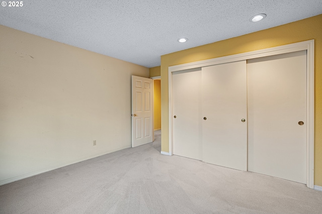 7785 SW Fairway Dr, Wilsonville, OR 97070 - unfurnished bedroom featuring light colored carpet, a closet, a textured ceiling, recessed lighting, and baseboards