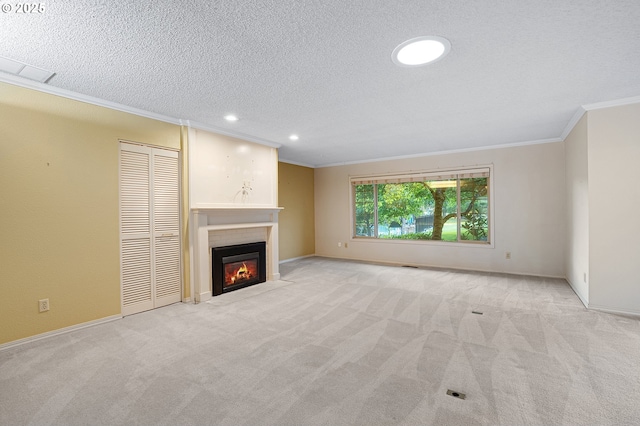 7785 SW Fairway Dr, Wilsonville, OR 97070 - unfurnished living room with crown molding, a fireplace with flush hearth, light carpet, a textured ceiling, and recessed lighting