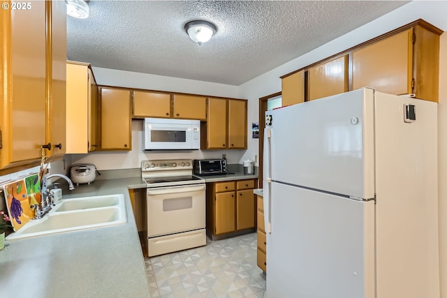 12330 SE Main St, Portland, OR 97233 - kitchen with white appliances, a sink, a textured ceiling, light countertops, and light flooring