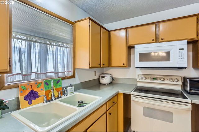 12330 SE Main St, Portland, OR 97233 - kitchen with white appliances, a sink, a textured ceiling, and light countertops