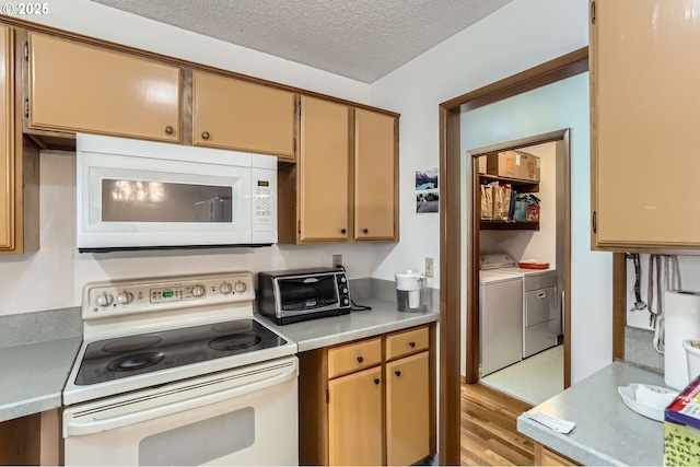 12330 SE Main St, Portland, OR 97233 - kitchen featuring white appliances, washer and clothes dryer, light countertops, light wood-style flooring, and a textured ceiling