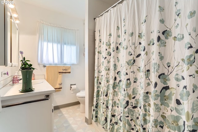 12330 SE Main St, Portland, OR 97233 - bathroom with vanity, toilet, baseboards, and a shower with shower curtain