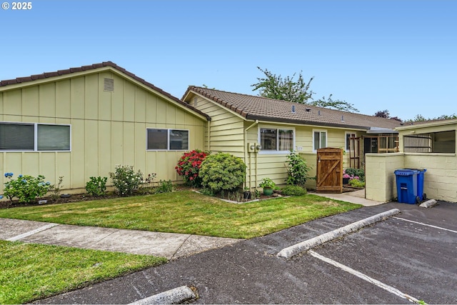 12330 SE Main St, Portland, OR 97233 - single story home with a tile roof, uncovered parking, a gate, and a front lawn