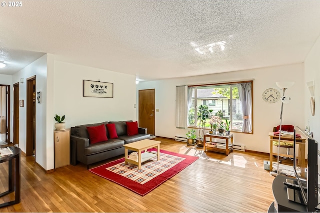 12330 SE Main St, Portland, OR 97233 - living room with a textured ceiling, wood-type flooring, a baseboard heating unit, and baseboards