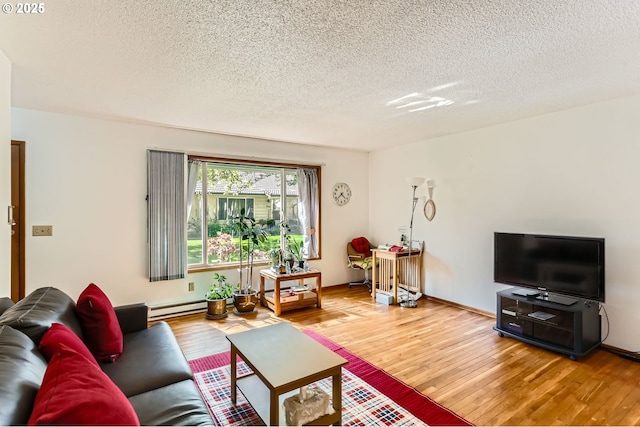 12330 SE Main St, Portland, OR 97233 - living room with a baseboard radiator, a textured ceiling, and light wood-type flooring