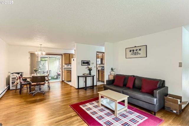 12330 SE Main St, Portland, OR 97233 - living room featuring a chandelier, light wood-style flooring, and a textured ceiling