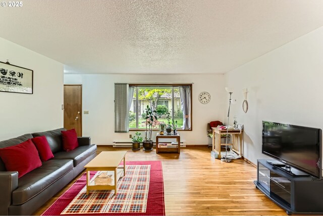 12330 SE Main St, Portland, OR 97233 - living area featuring light wood-style flooring, a textured ceiling, and baseboard heating