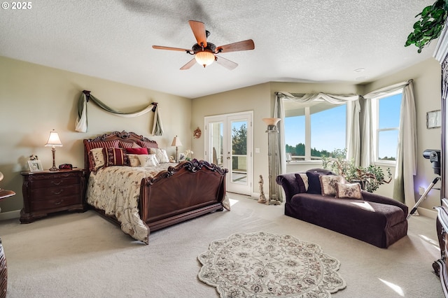 carpeted bedroom featuring a textured ceiling, access to exterior, ceiling fan, and french doors