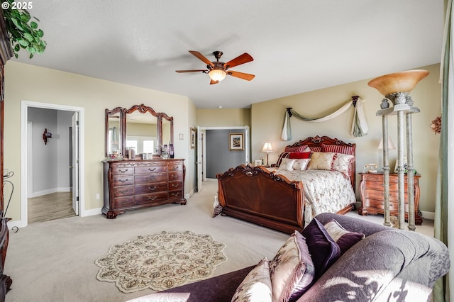 bedroom with light colored carpet and ceiling fan