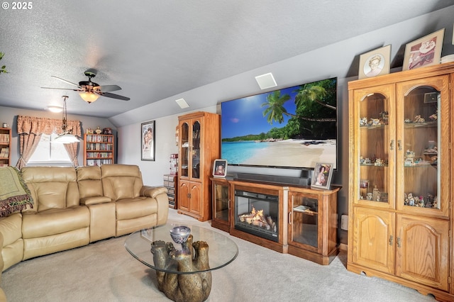 carpeted living room featuring ceiling fan, vaulted ceiling, and a textured ceiling