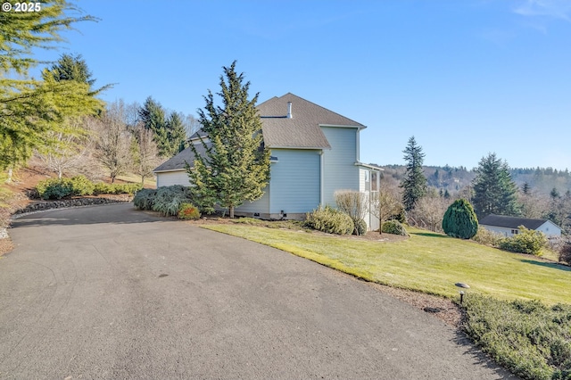 view of side of property with a lawn