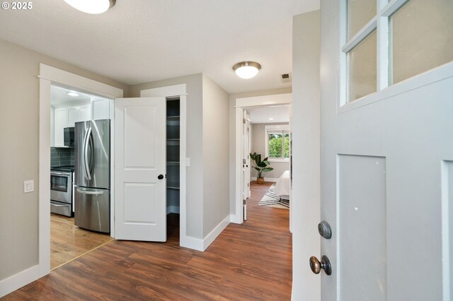 bedroom with a closet and dark hardwood / wood-style flooring