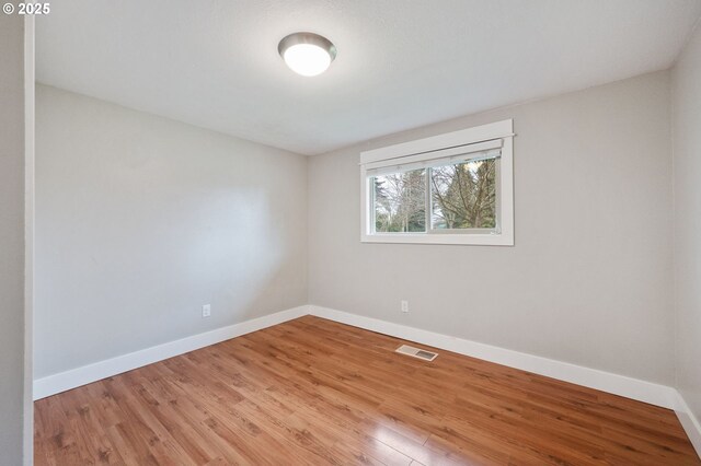 unfurnished room with light hardwood / wood-style flooring