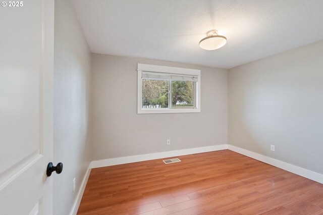 unfurnished bedroom with a closet and hardwood / wood-style flooring