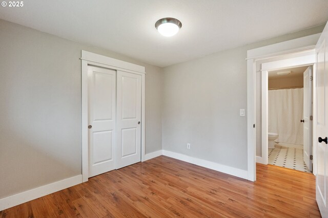 washroom with a textured ceiling, dark wood-type flooring, cabinets, electric dryer hookup, and hookup for a washing machine