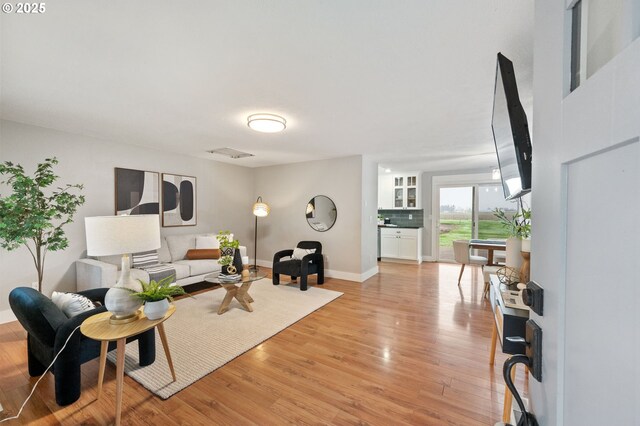 living room with light hardwood / wood-style flooring