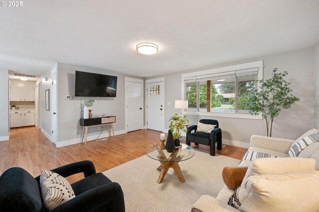 kitchen featuring sink, white cabinetry, light hardwood / wood-style flooring, and stainless steel appliances