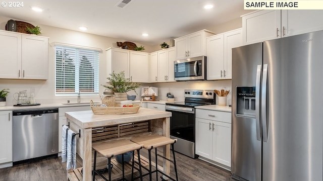 kitchen featuring appliances with stainless steel finishes, light countertops, visible vents, and a sink