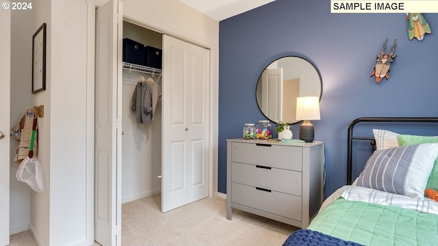 bedroom with baseboards, a closet, and light colored carpet