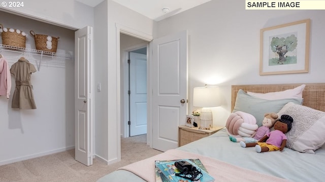 bedroom with baseboards and light colored carpet