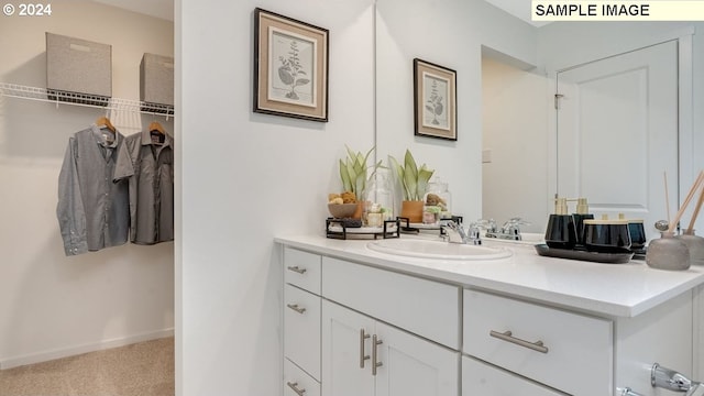 bathroom featuring baseboards and vanity