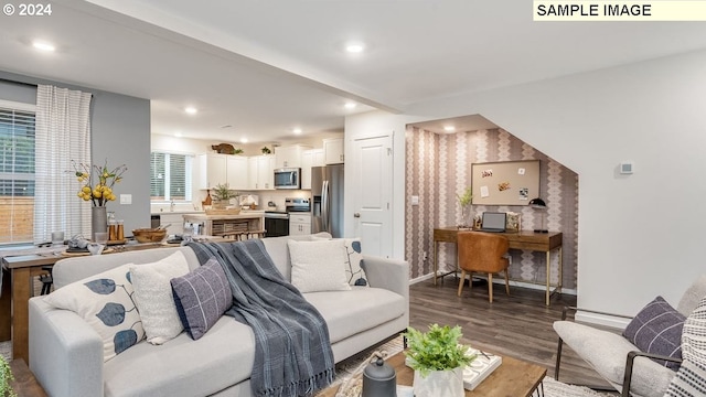 living area with recessed lighting, wallpapered walls, baseboards, and wood finished floors