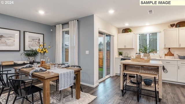 dining room with baseboards, visible vents, dark wood-type flooring, and recessed lighting