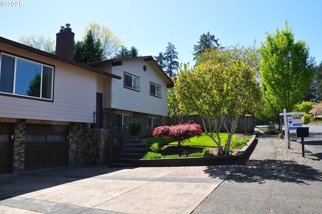 13950 SW Barlow Rd, Beaverton, OR 97008 - view of front of property with stone siding, concrete driveway, a chimney, a garage, and stairway