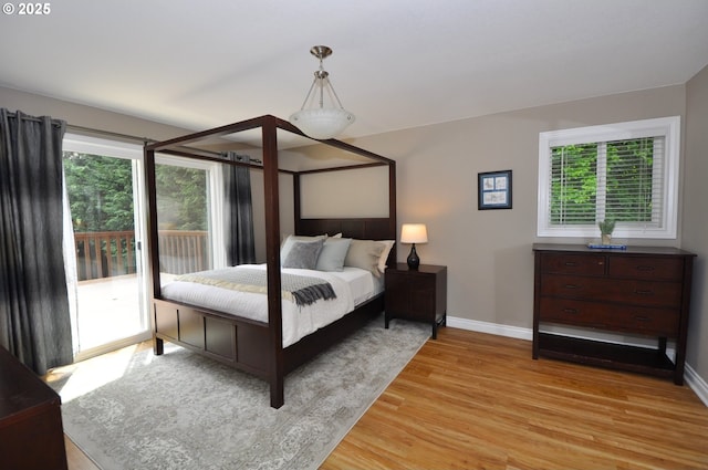13950 SW Barlow Rd, Beaverton, OR 97008 - bedroom with baseboards, light wood finished floors, and access to exterior