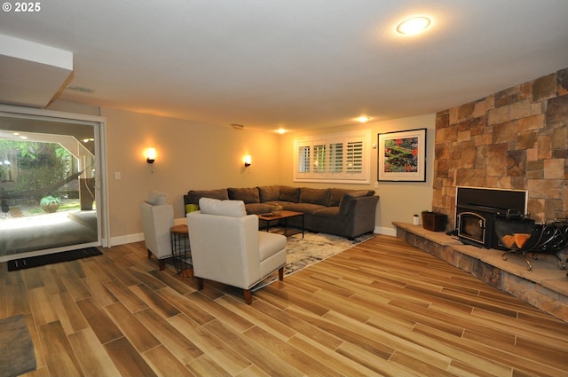 13950 SW Barlow Rd, Beaverton, OR 97008 - living room with wood finished floors, baseboards, and a wood stove