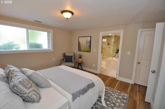 13950 SW Barlow Rd, Beaverton, OR 97008 - bedroom featuring wood finished floors, baseboards, and ensuite bath