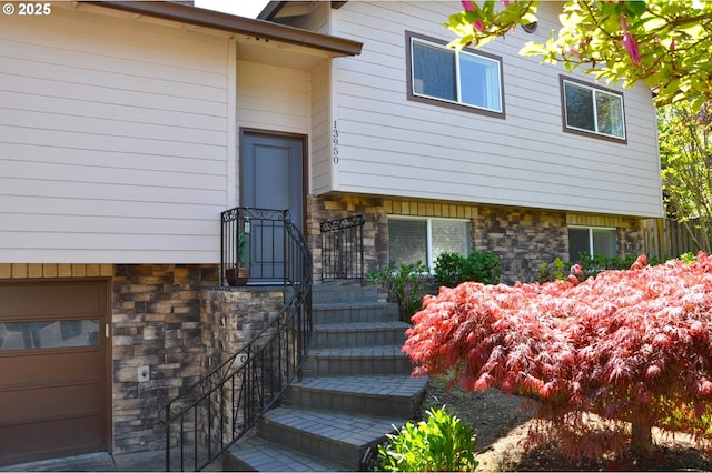 13950 SW Barlow Rd, Beaverton, OR 97008 - doorway to property with stone siding and a garage
