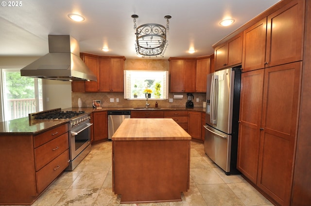 13950 SW Barlow Rd, Beaverton, OR 97008 - kitchen with appliances with stainless steel finishes, island range hood, wood counters, healthy amount of natural light, and recessed lighting