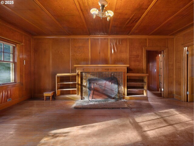 doorway to outside with wooden ceiling and wooden walls