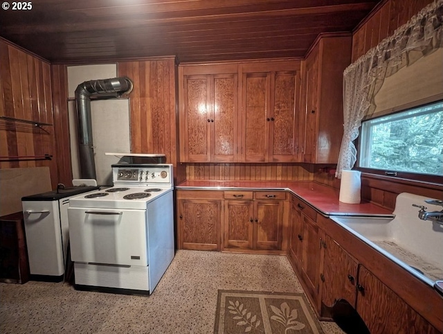 kitchen featuring electric range, wooden walls, wooden ceiling, and sink