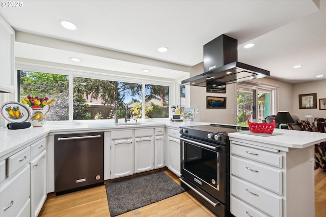 11820 SW Reid Ct, Beaverton, OR 97008 - kitchen with stainless steel dishwasher, electric range, wall chimney exhaust hood, a peninsula, and white cabinets
