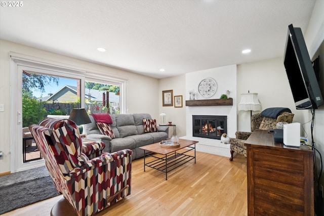 11820 SW Reid Ct, Beaverton, OR 97008 - living area with light wood-type flooring, a fireplace, and recessed lighting