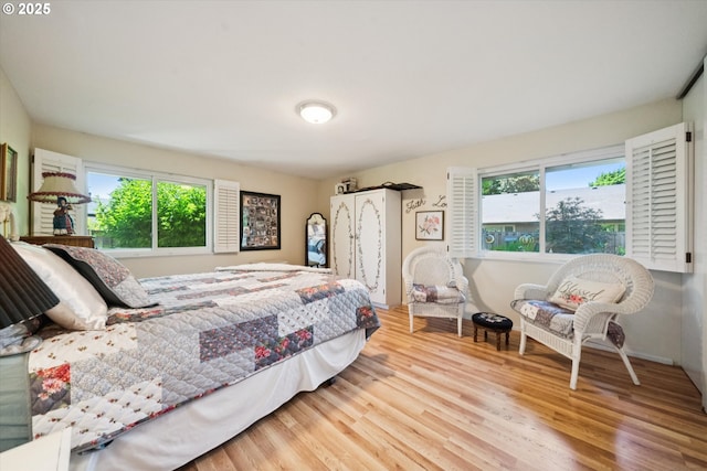 11820 SW Reid Ct, Beaverton, OR 97008 - bedroom with multiple windows and wood finished floors