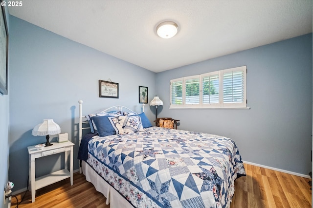 11820 SW Reid Ct, Beaverton, OR 97008 - bedroom featuring baseboards and wood finished floors