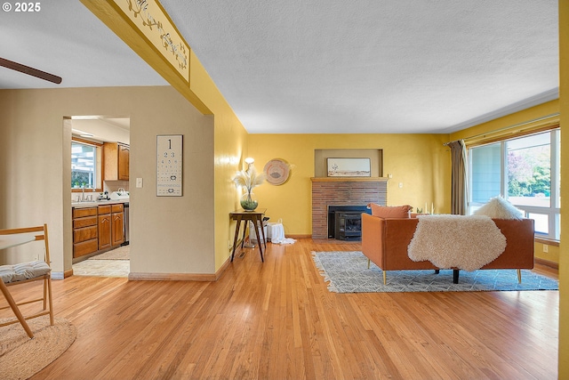 3116 Vista Dr, Forest Grove, OR 97116 - living area with a brick fireplace, light wood-type flooring, and a healthy amount of sunlight