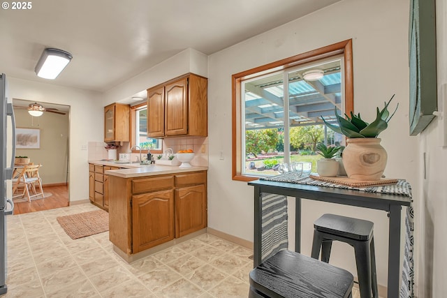 3116 Vista Dr, Forest Grove, OR 97116 - kitchen with a peninsula, light countertops, baseboards, and brown cabinets