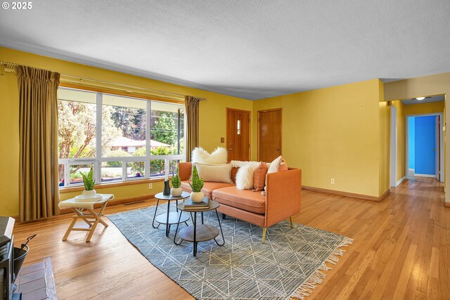 3116 Vista Dr, Forest Grove, OR 97116 - living room featuring a textured ceiling, light wood finished floors, and baseboards